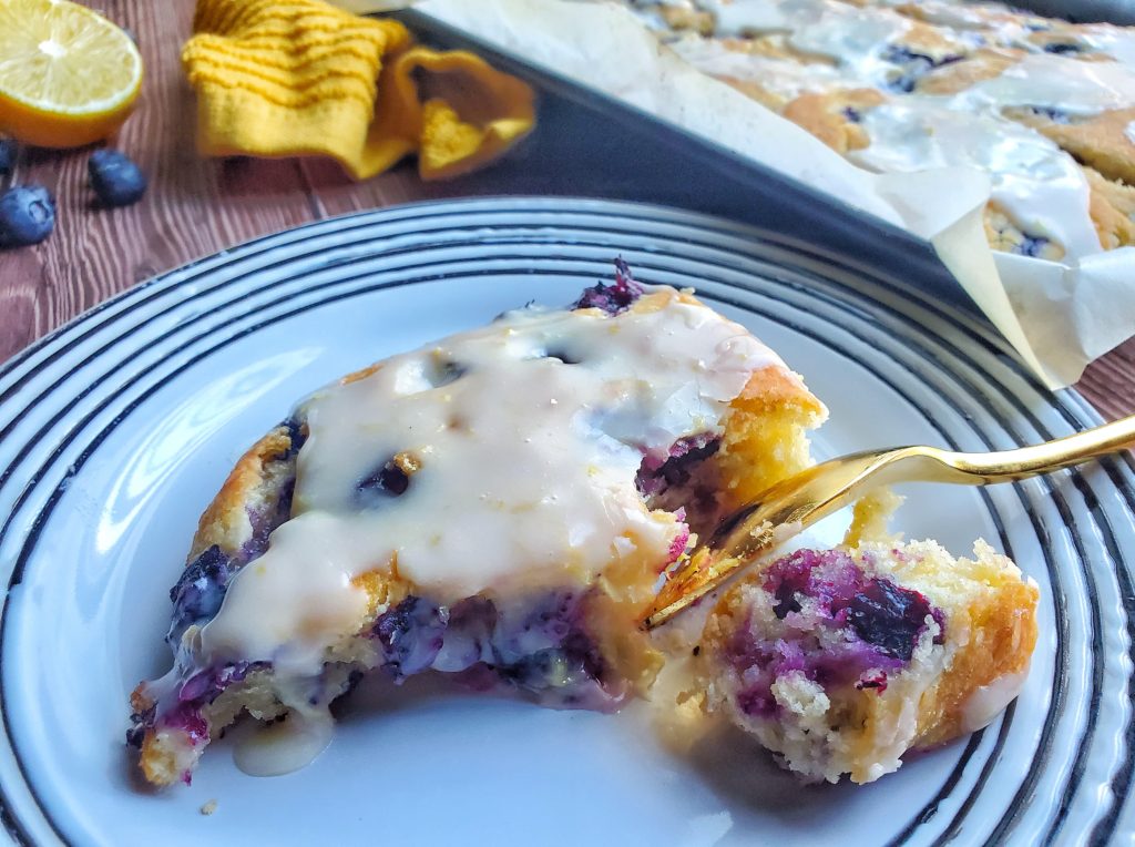 Blueberry Biscuits with Lemon Glaze On A Plate With A Spoon