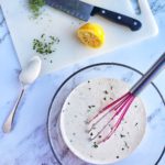 Homemade Buttermilk Ranch Dressing In A Bowl Next To Cutting Board