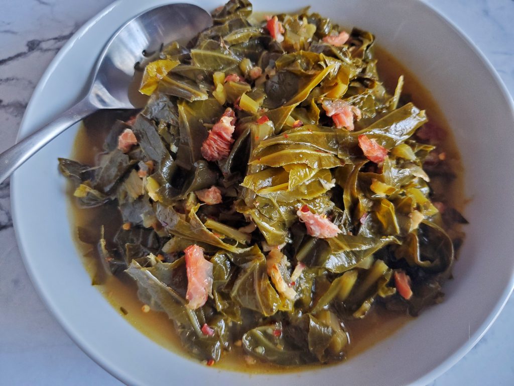 Slow Cooked Southern Style Collard Greens With A Spoon