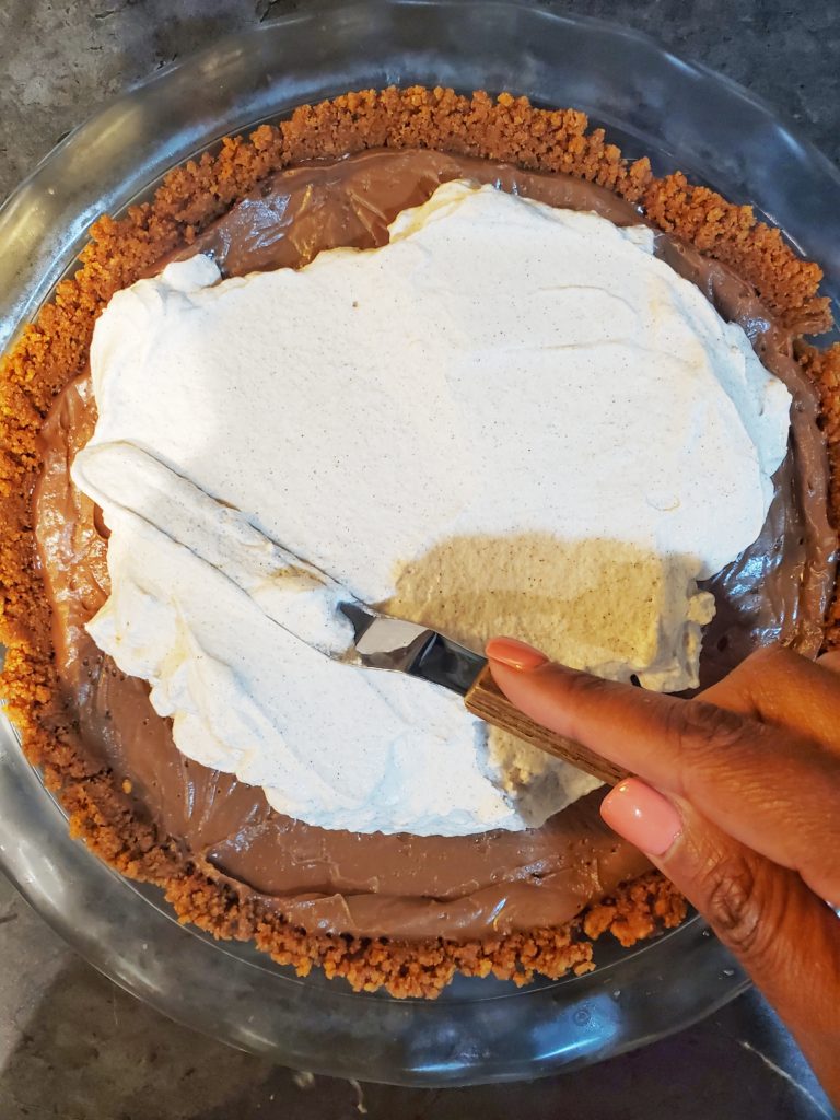 Whipped topping spread onto pudding pie