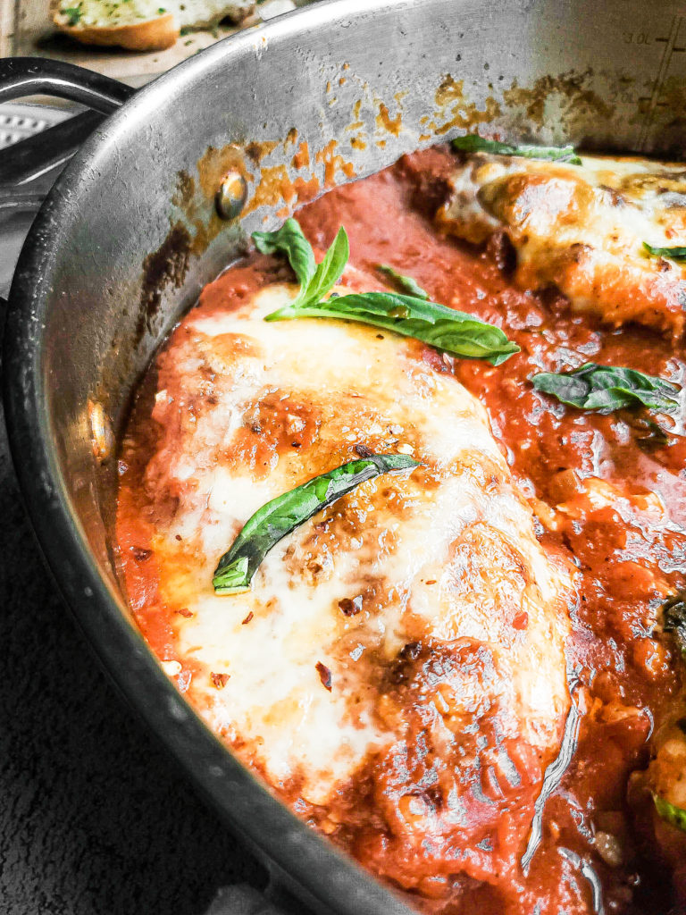 Close up of chicken parmesan in a skillet