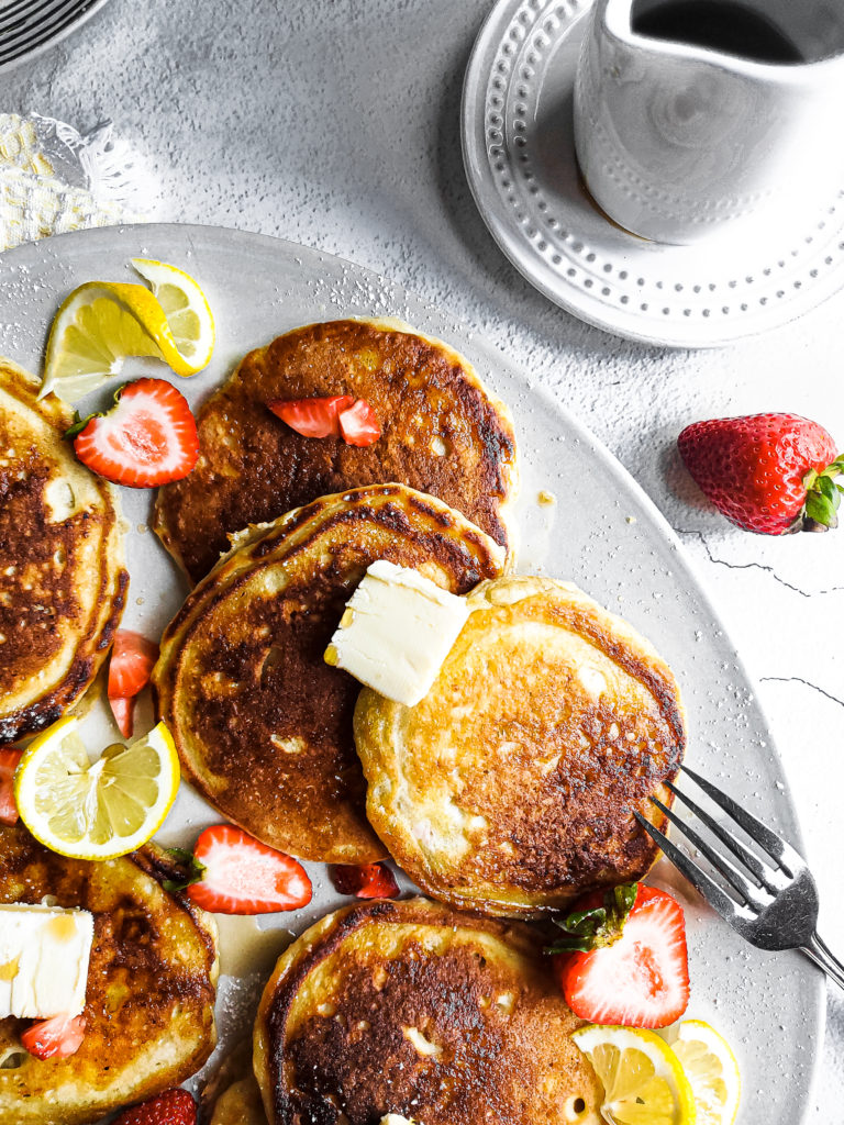 Lemon ricotta pancakes with strawberries on a platter