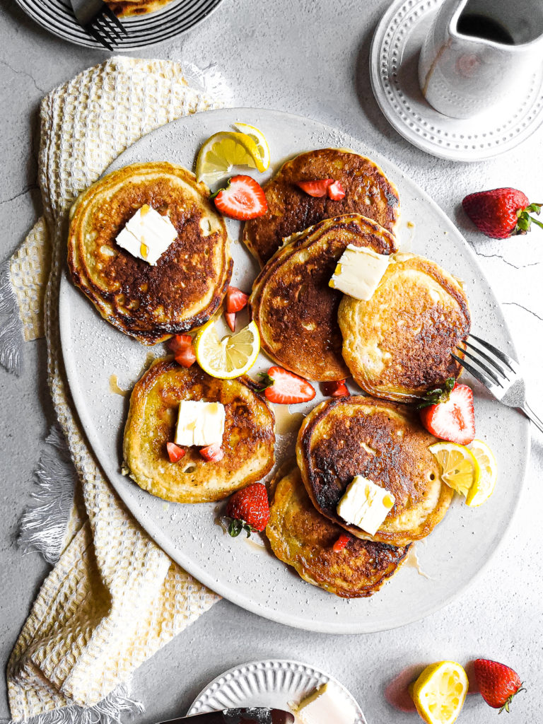 Lemon ricotta pancakes with strawberries on a platter