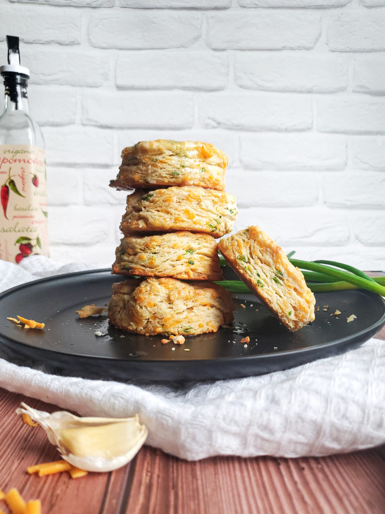 Stack of cheddar scallion biscuits on a plate