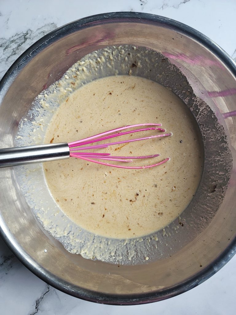 Mixing bowl of milk and egg mixture for bread pudding