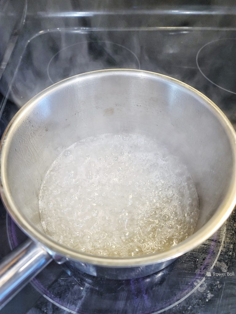 Water and sugar simmering for caramel sauce