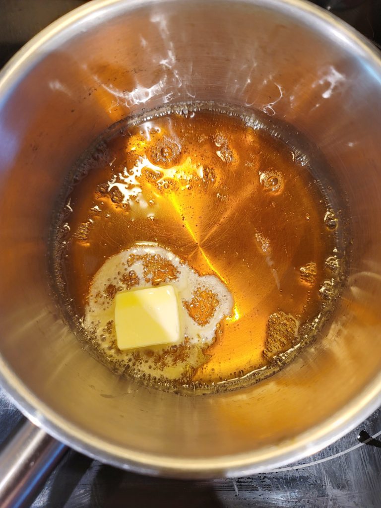 Butter added to caramelized sugar and water to make caramel sauce