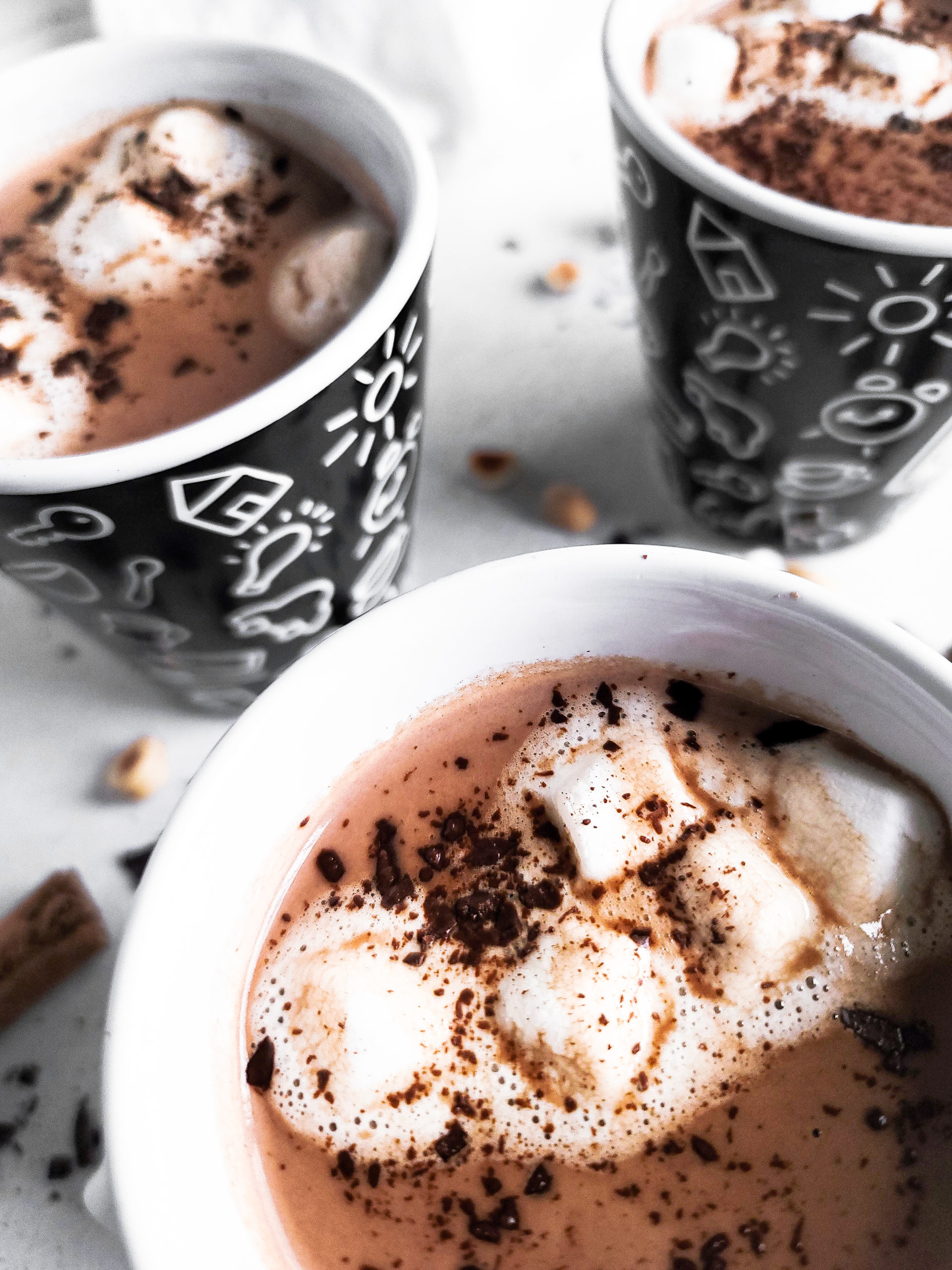 Close up picture of 3 mugs full of hot chocolate