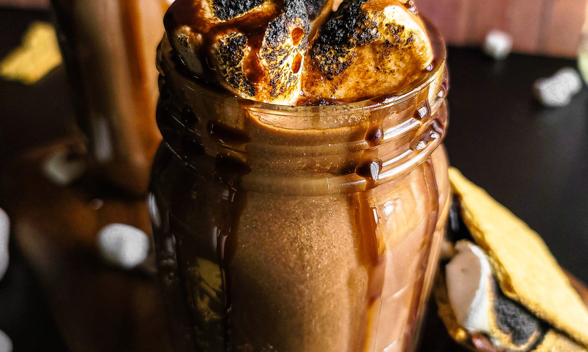 2 glass jars with smores hot chocolate with roasted marshmallows