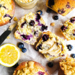 Overhead shot of blueberry lemon poppyseed corn muffins with a smear of vanilla honey butter