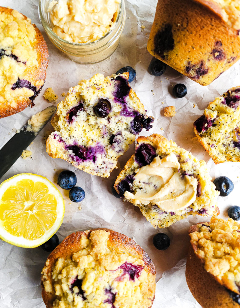 Overhead shot of blueberry lemon poppyseed corn muffins  with a smear of vanilla honey butter